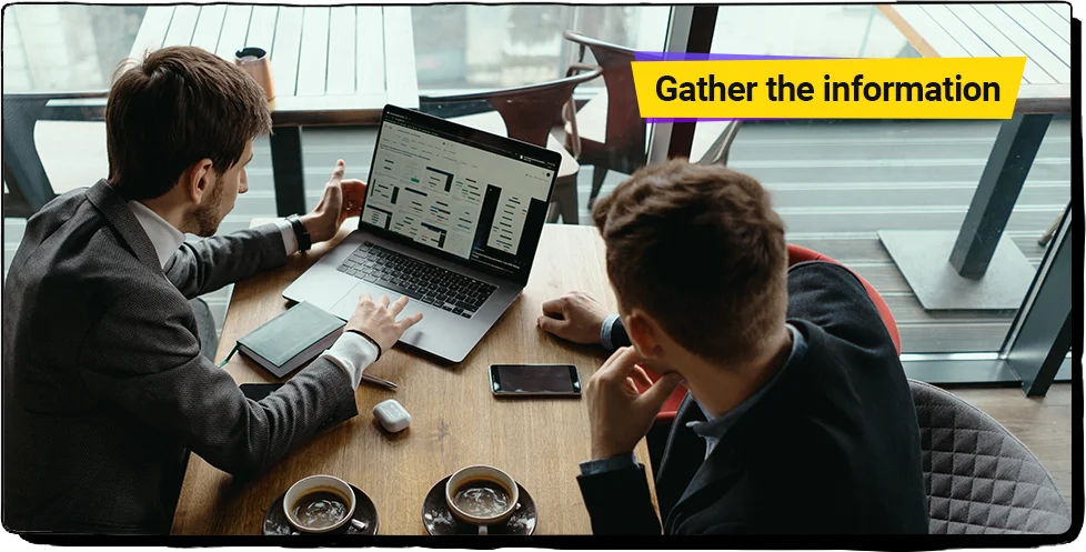 two persons are working together on laptop